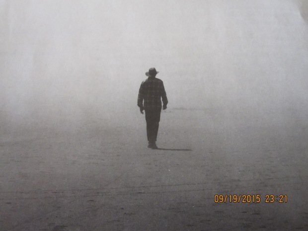 A photo from The Sun Magazine, a solitary form walking in the mist.